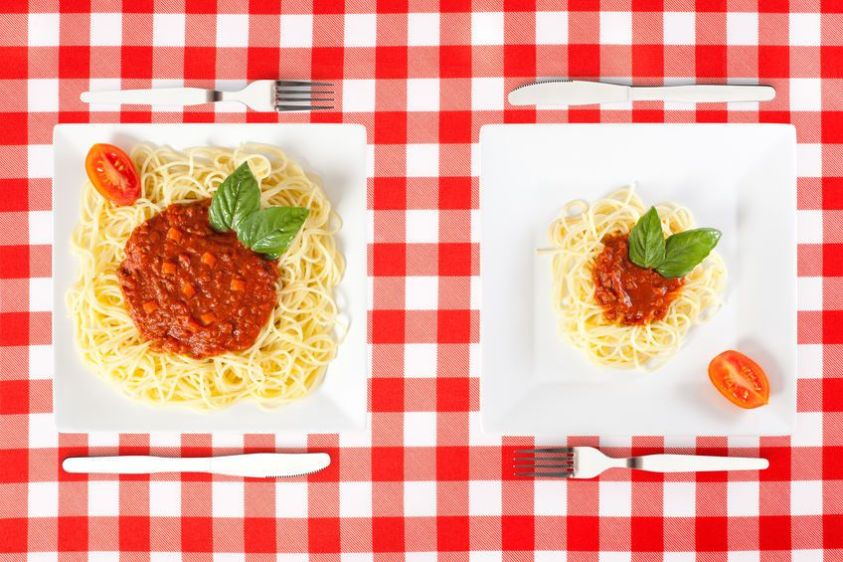 Contrasting large and tiny food portions of Spaghetti Contrasting large and tiny food portions of Spaghetti