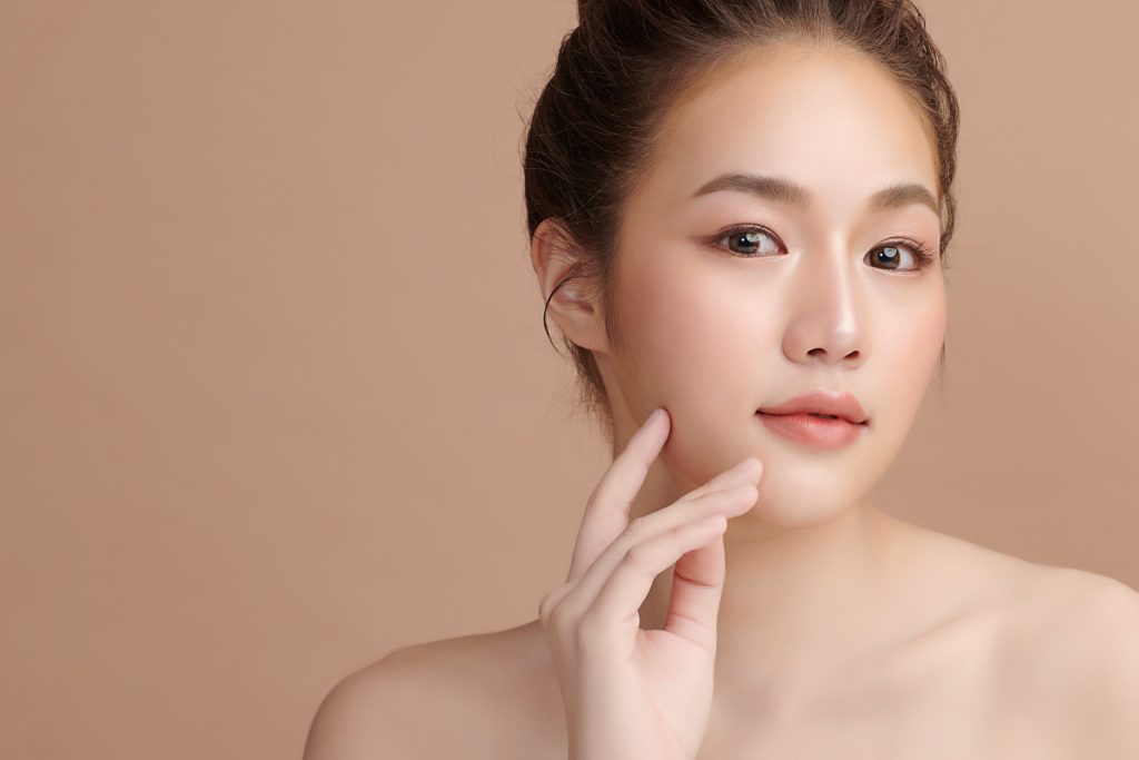 Beautiful young asian woman with clean fresh skin on beige background, Face care, Facial treatment, Cosmetology, beauty and spa, Asian women portrait.
